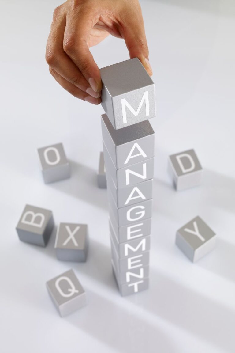 image of cibes with letters on with a hand building a tower spelling management